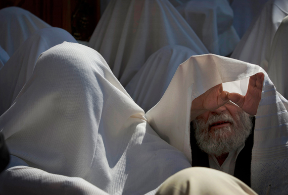 Covered in prayer shawls, Ultra-Orthodox Jewish men of the Cohanim Priestly caste participate in a blessing during Sukkot in front of the Western Wall, the holiest site Jews pray in Jerusalem's Old City, Oct. 16, 2011. The Cohanim, believed to be descendants of priests who served God in the Jewish Temple before it was destroyed, perform a blessing ceremony of the Jewish people three times a year during the festivals of Passover, Shavuot and Sukkot.